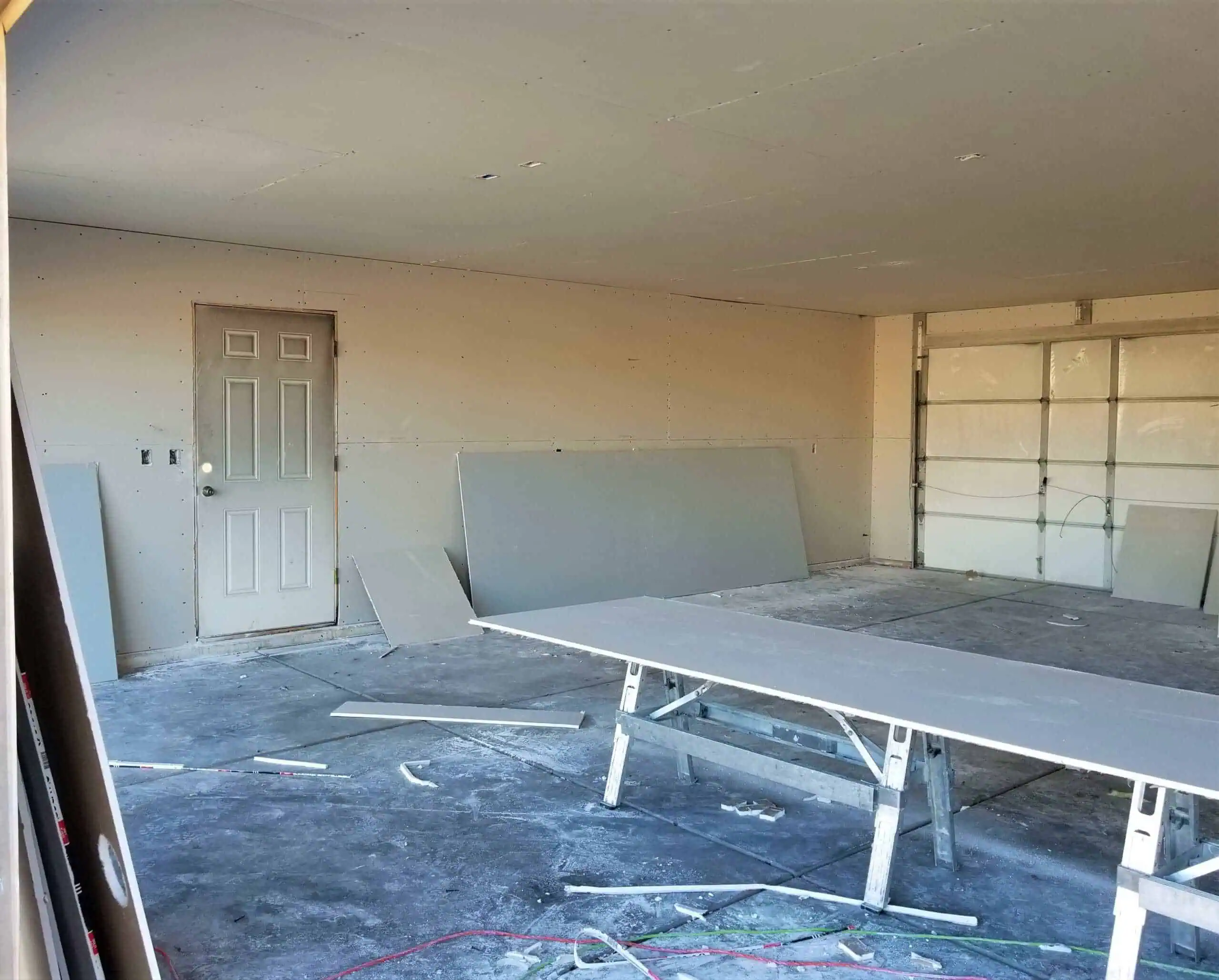 Interior drywall construction for garage renovation.