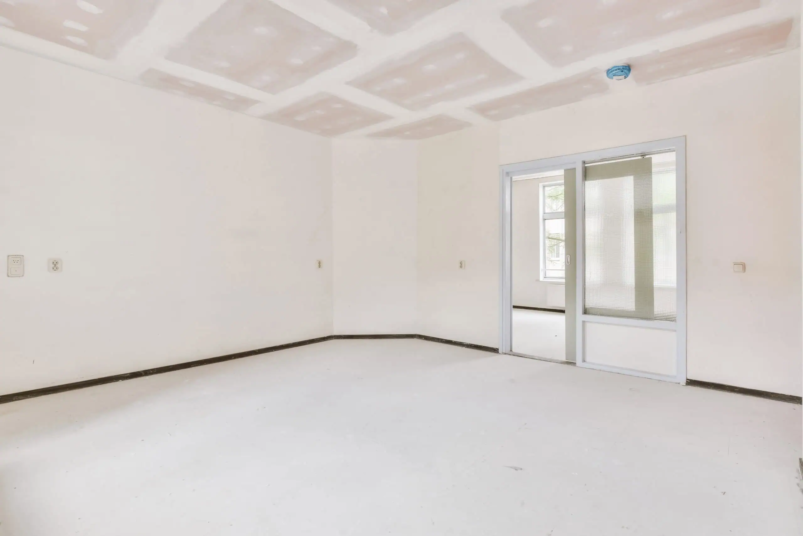 Drywall installation in a new residential interior space.