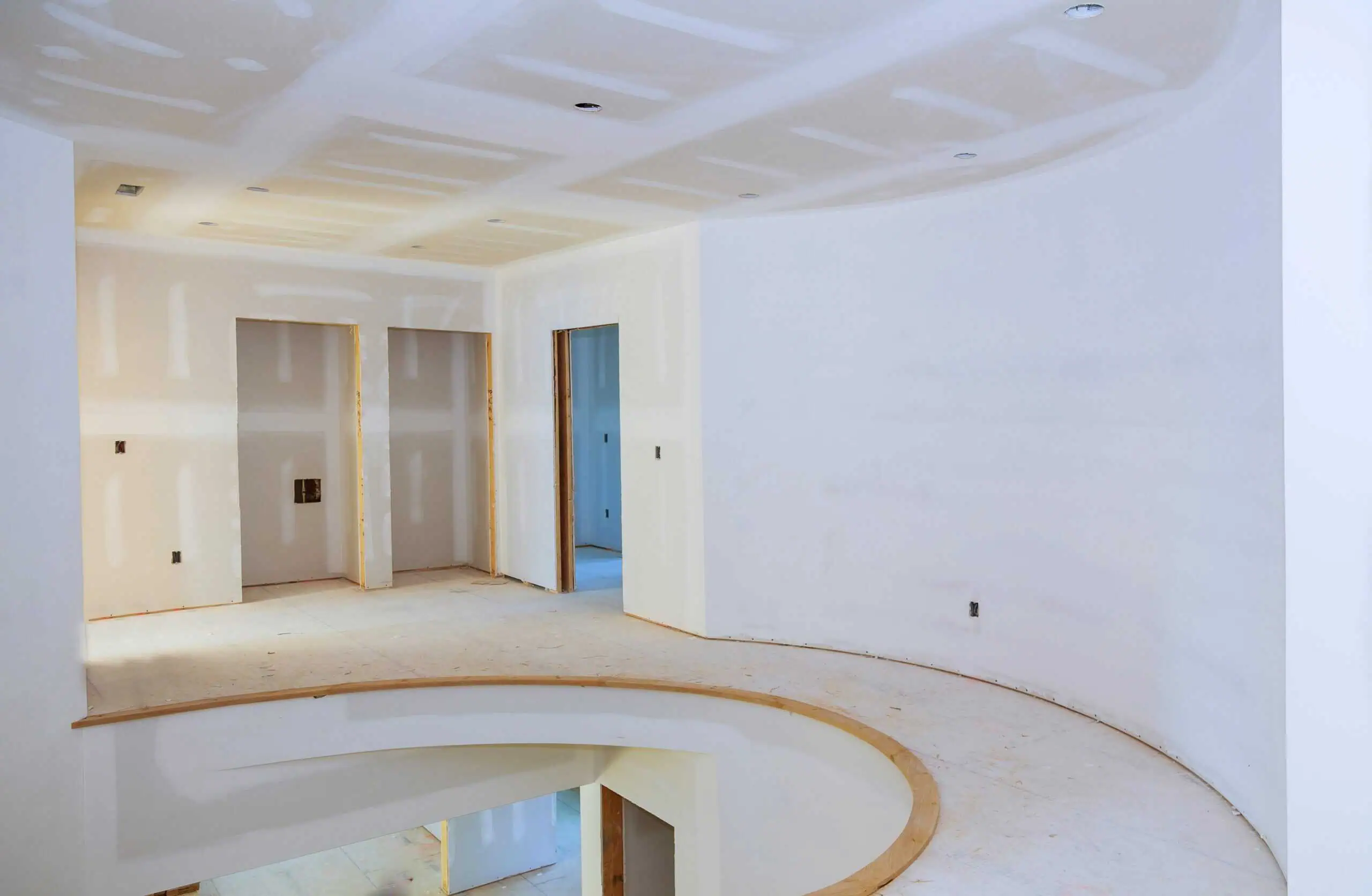 Drywall installation in a modern interior with curved walls and ceiling, showcasing professional dry.