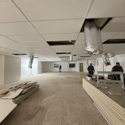 Ceiling with drywall panels and ductwork in progress.