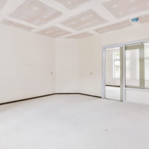 Drywall installation in a new residential interior space.